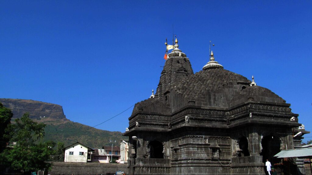Trimbakeshwar Mandir spire against a clear blue sky.
