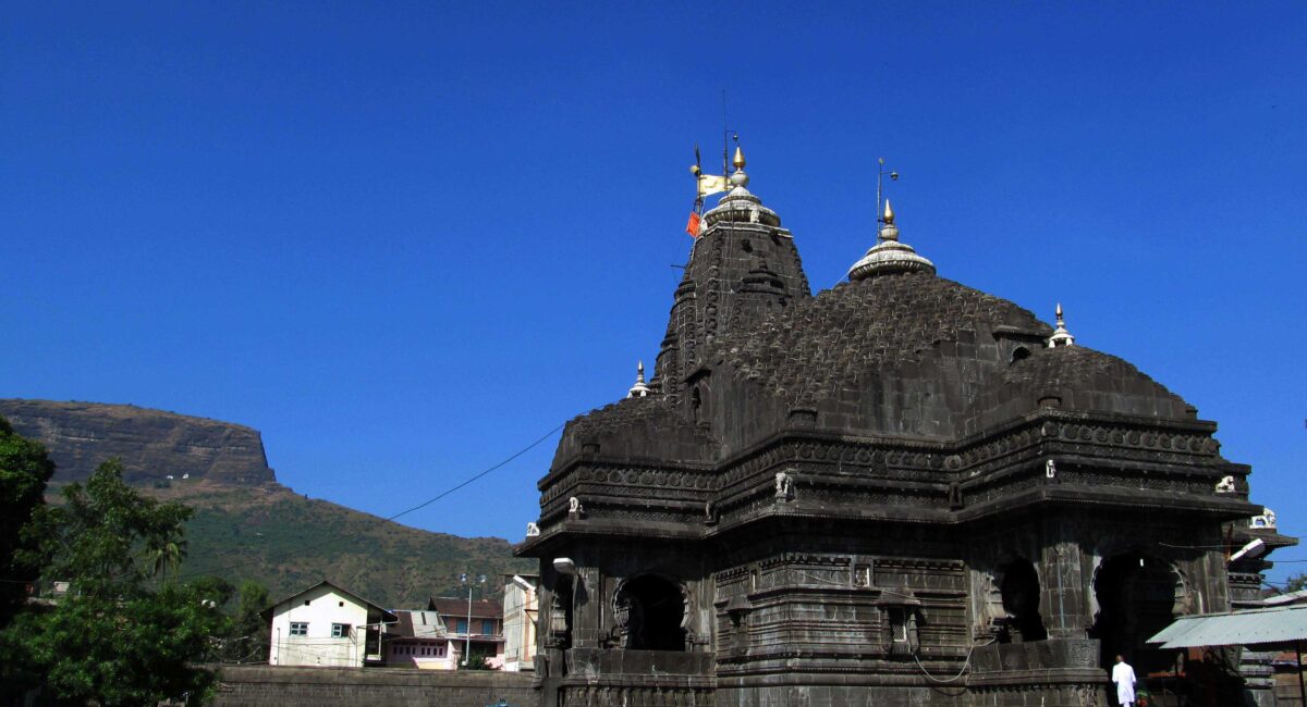 Trimbakeshwar Mandir spire against a clear blue sky.