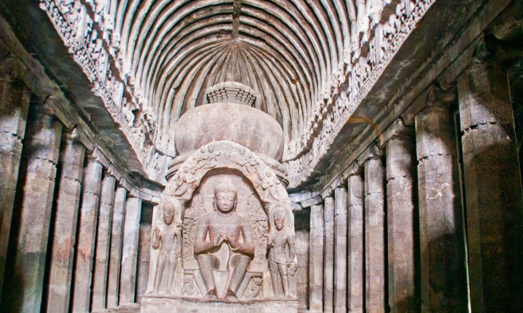 Entrance to Buddhist cave at Ellora Caves in India with carved pillars