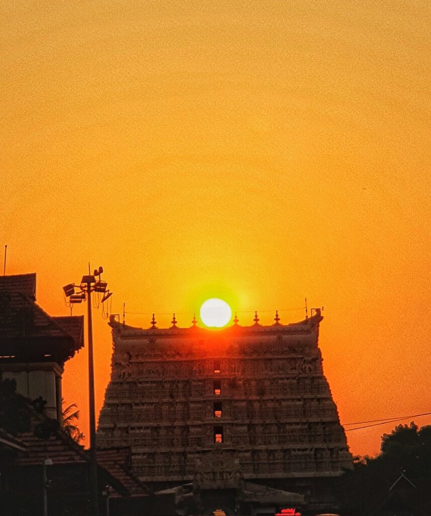 The golden sunset hitting the seven-tiered Gopuram of the Padmanabhaswamy Temple in Thiruvananthapuram.